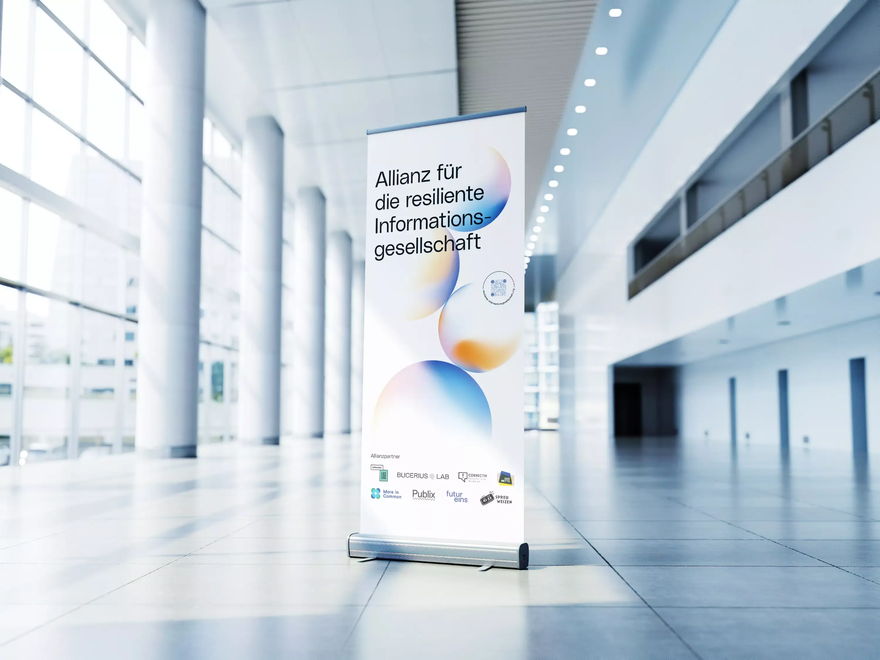 Roll-up banner in a bright hall with the text \