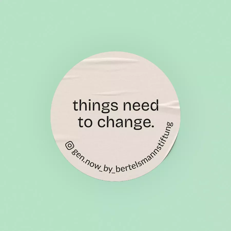 Round sticker on a mint green background with the text \