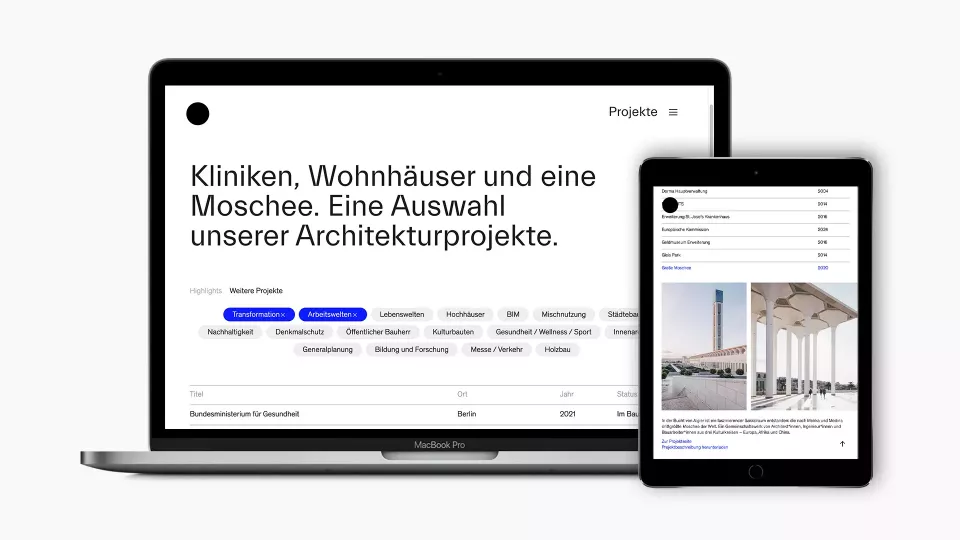 Open laptop and tablet displaying the KSP Engel Architekten website show an overview of projects and the details page for a specific project