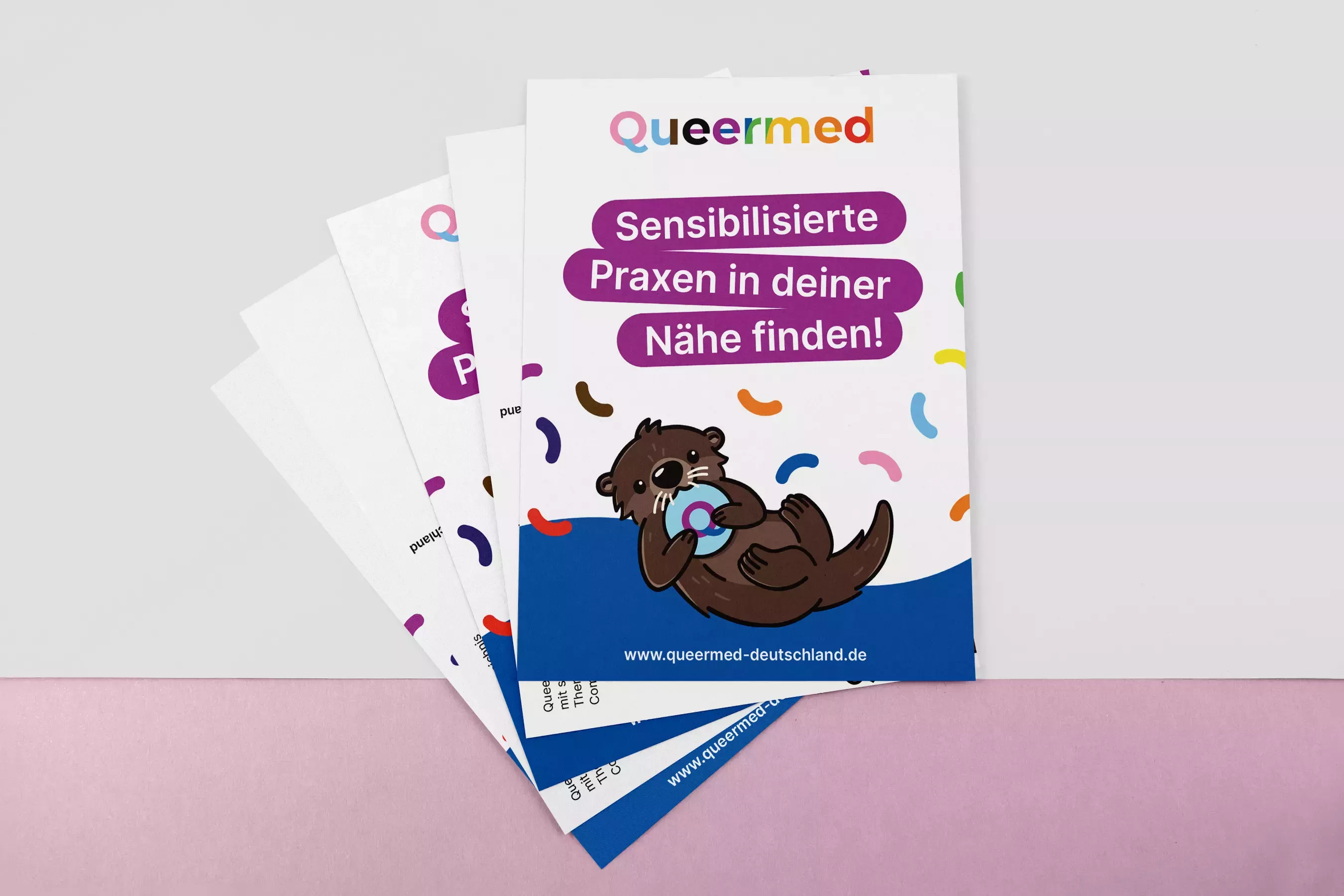 Stacked flyers with the Queermed logo, otter illustration, and text \