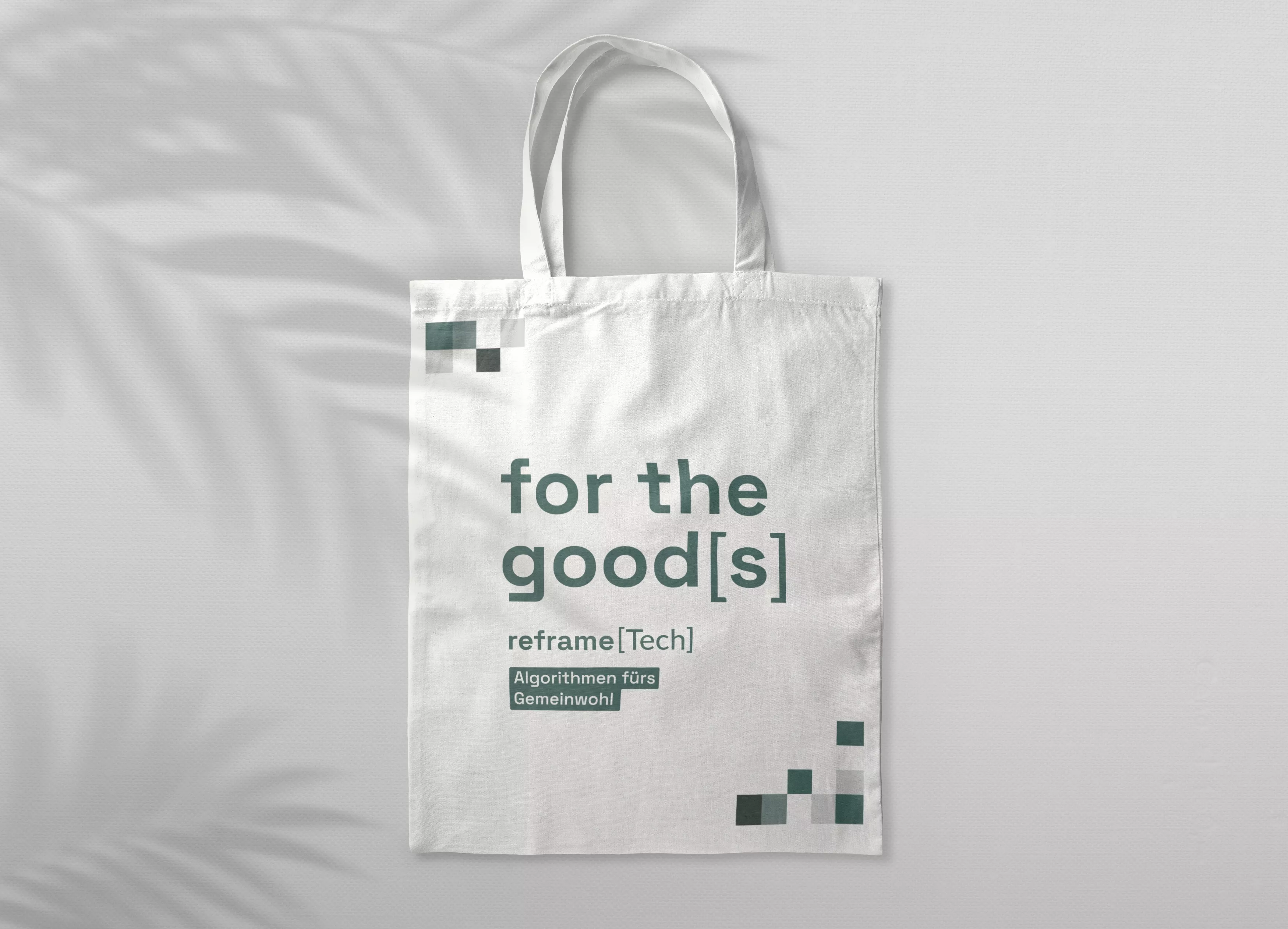 White cloth bag with petrol-colored print \