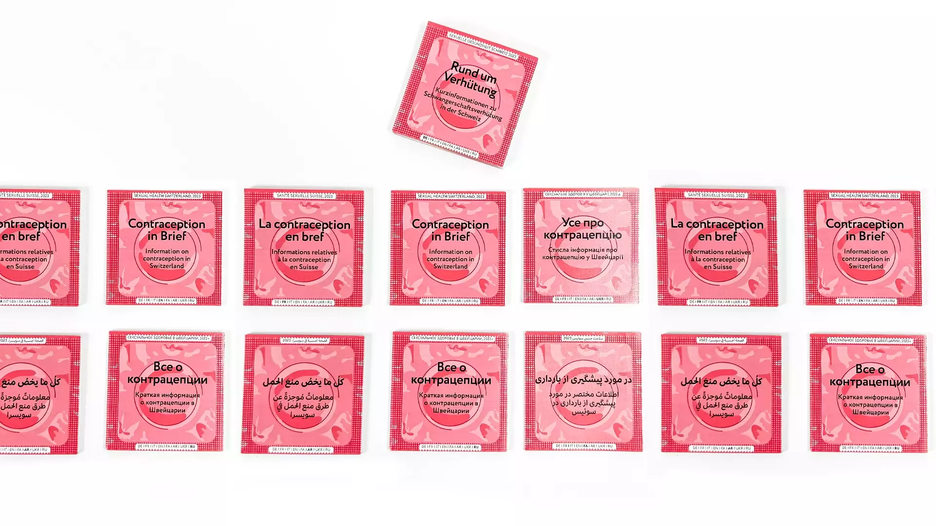 Several information brochures designed to look like condom packaging with a red background, labeled in various languages with information on contraception in Switzerland
